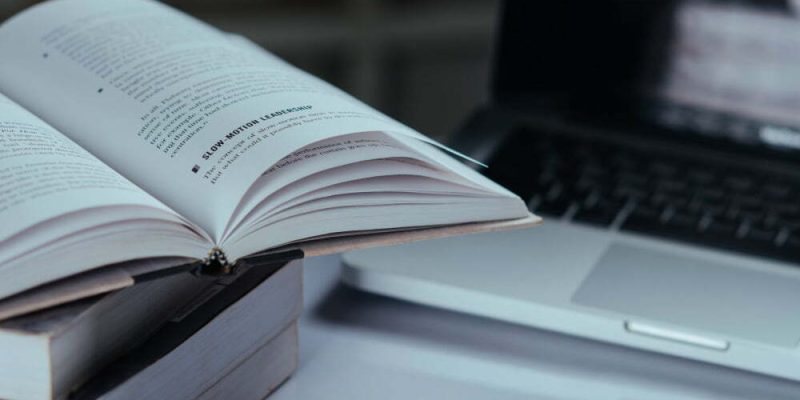 education-concept-books-and-laptop-at-library